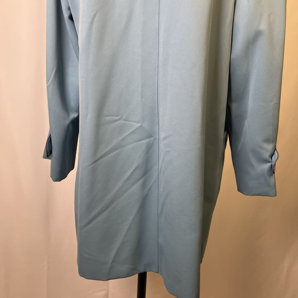 Light blue dress on a mannequin against a beige background