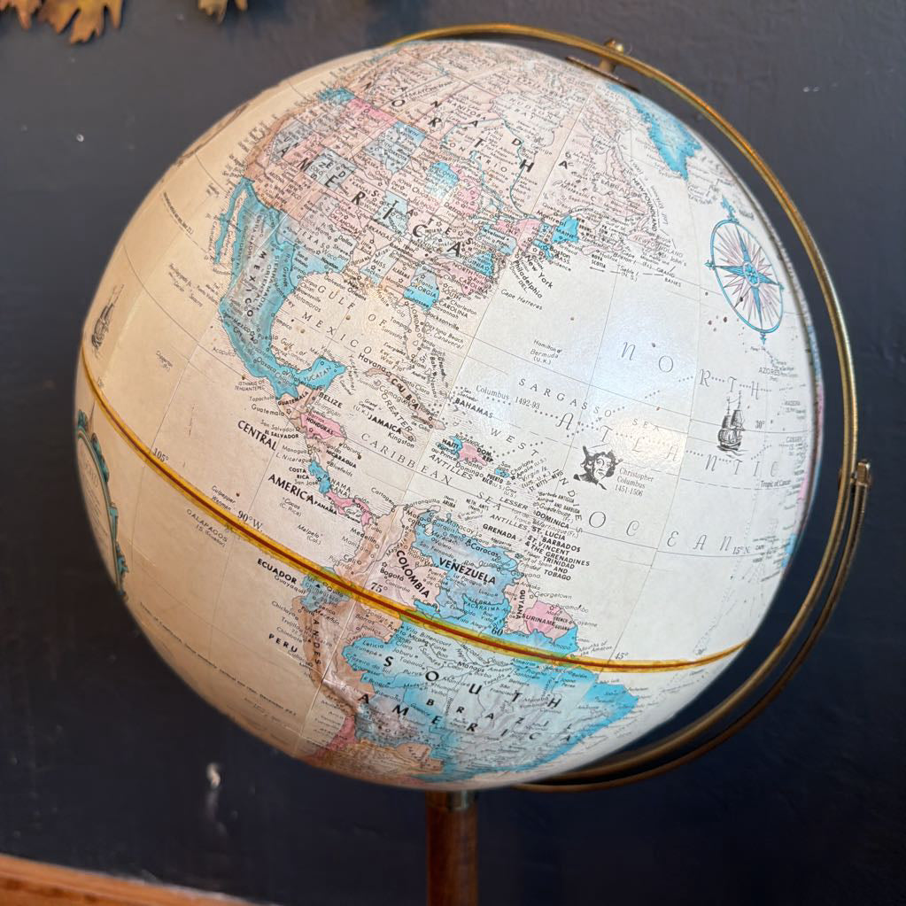 Close-up of a vintage-style globe with detailed world map on a dark background