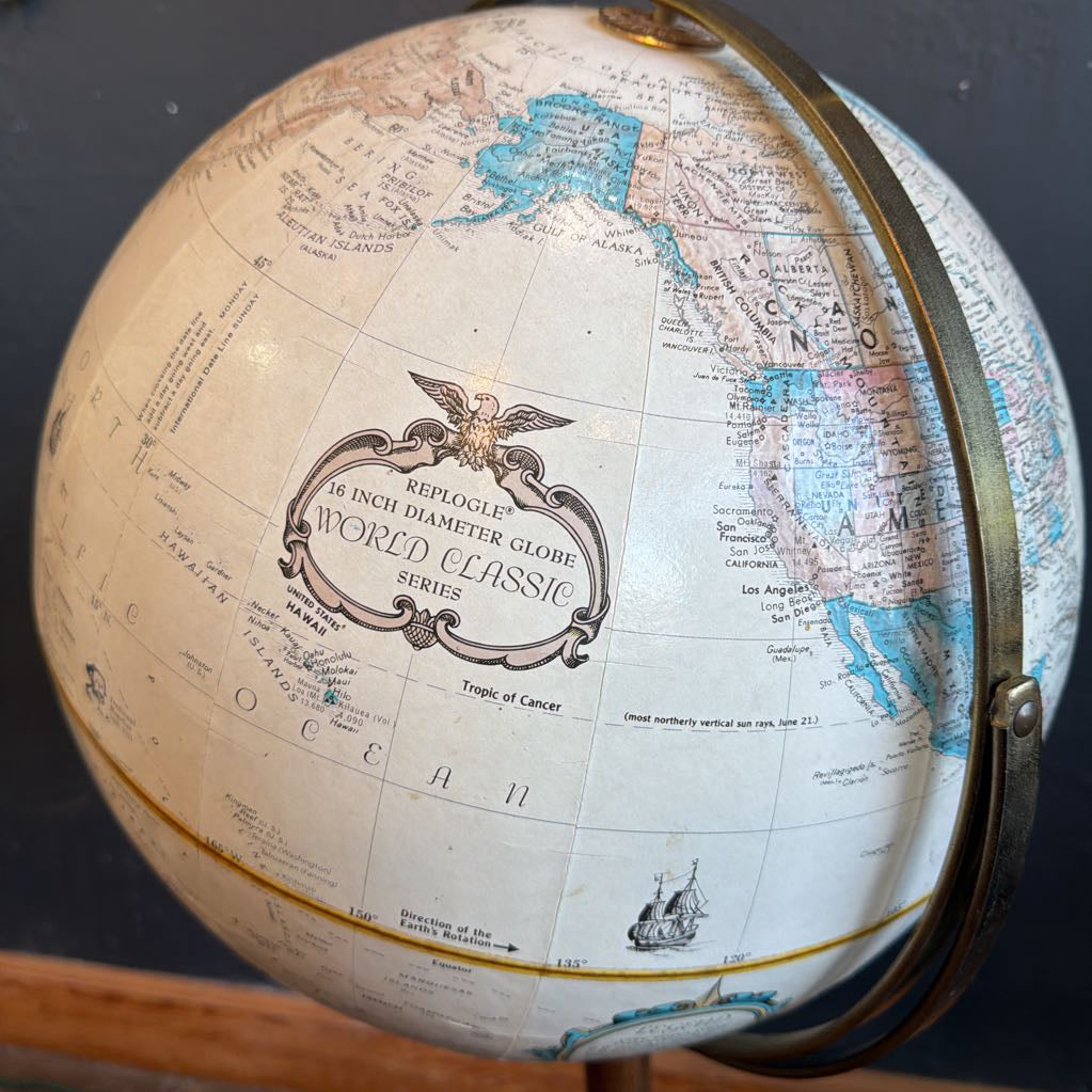 Close-up of a vintage-style world globe with detailed map and brand name.