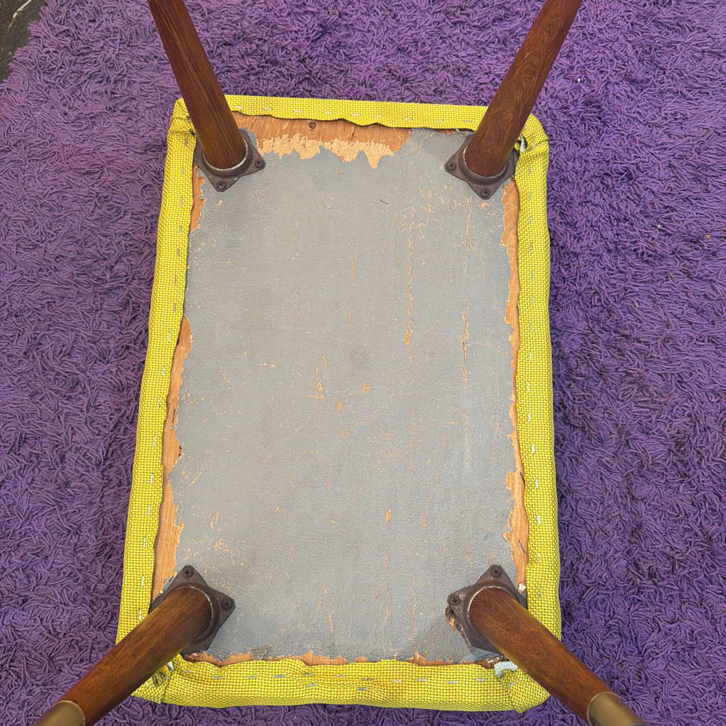 Rectangular patch of gray material with yellow border on a purple textured surface