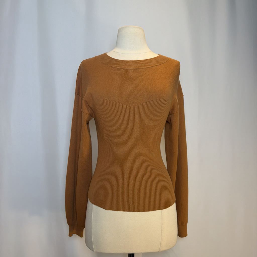 Brown sweater on a mannequin against a plain background