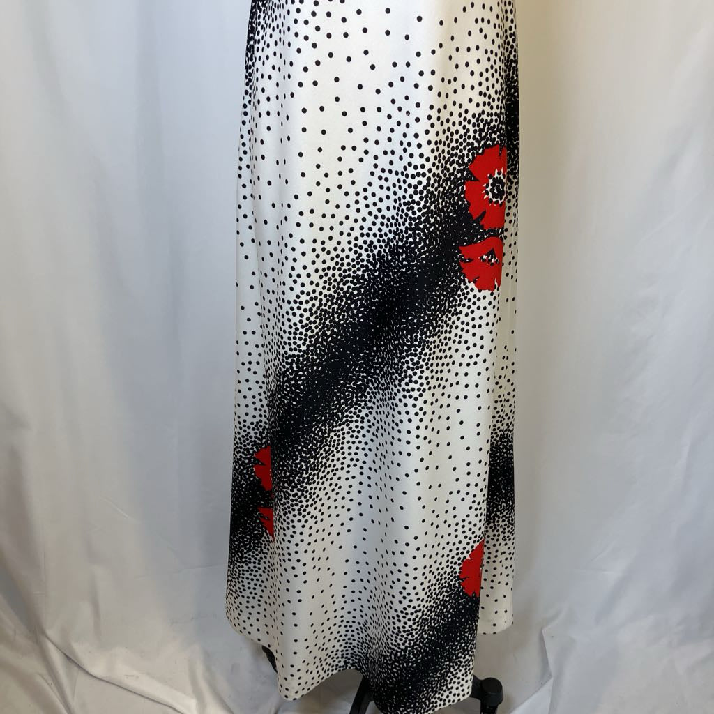 Black and white polka dot pattern with red accents on a white background