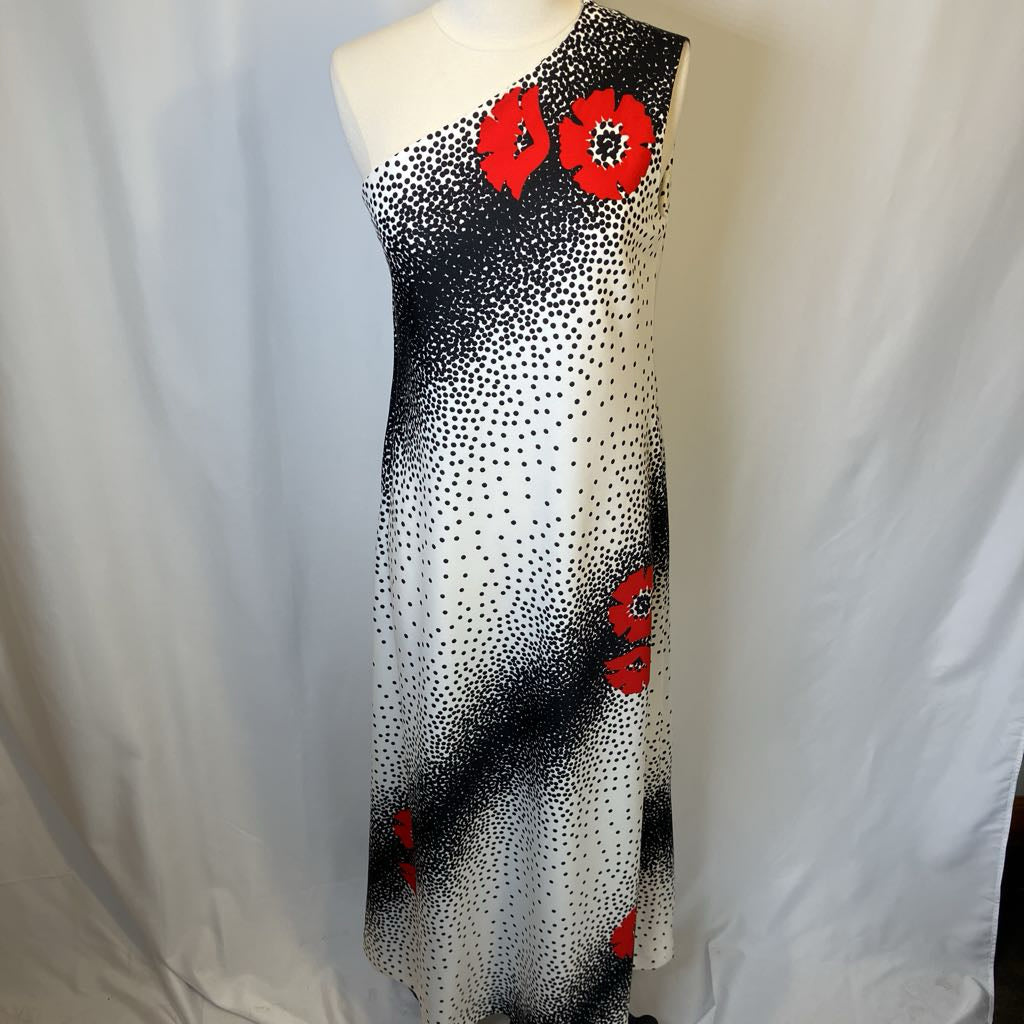 Dress with black and white pattern and red floral accents on a mannequin against a white background