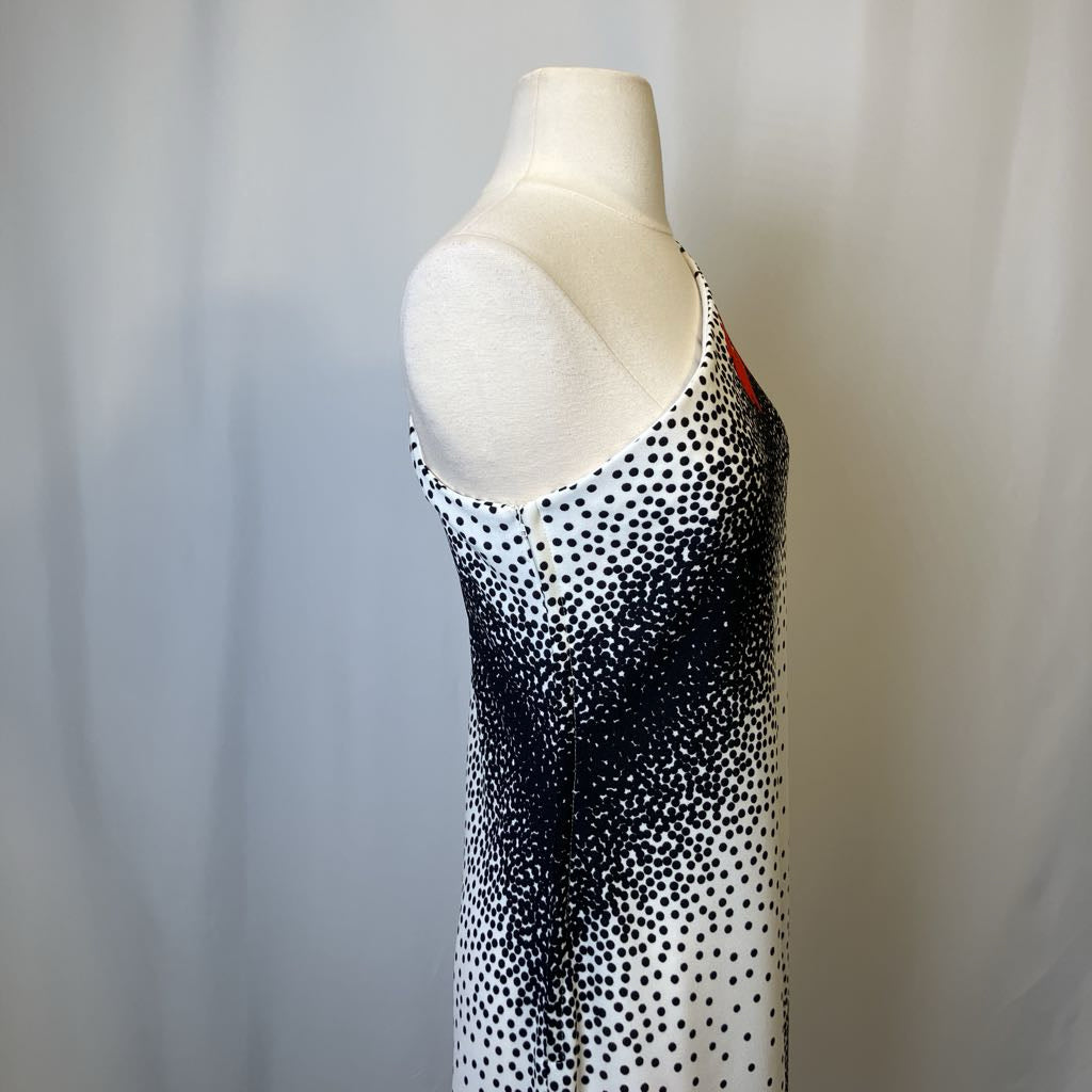 Mannequin wearing a black and white polka dot dress against a plain background