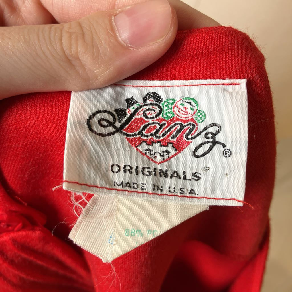 Close-up of a red garment with a 'Lambs Originals' label.