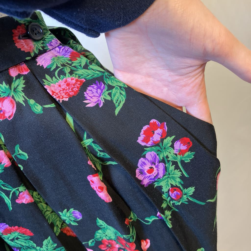 Floral patterned fabric pocket held by a person's hand
