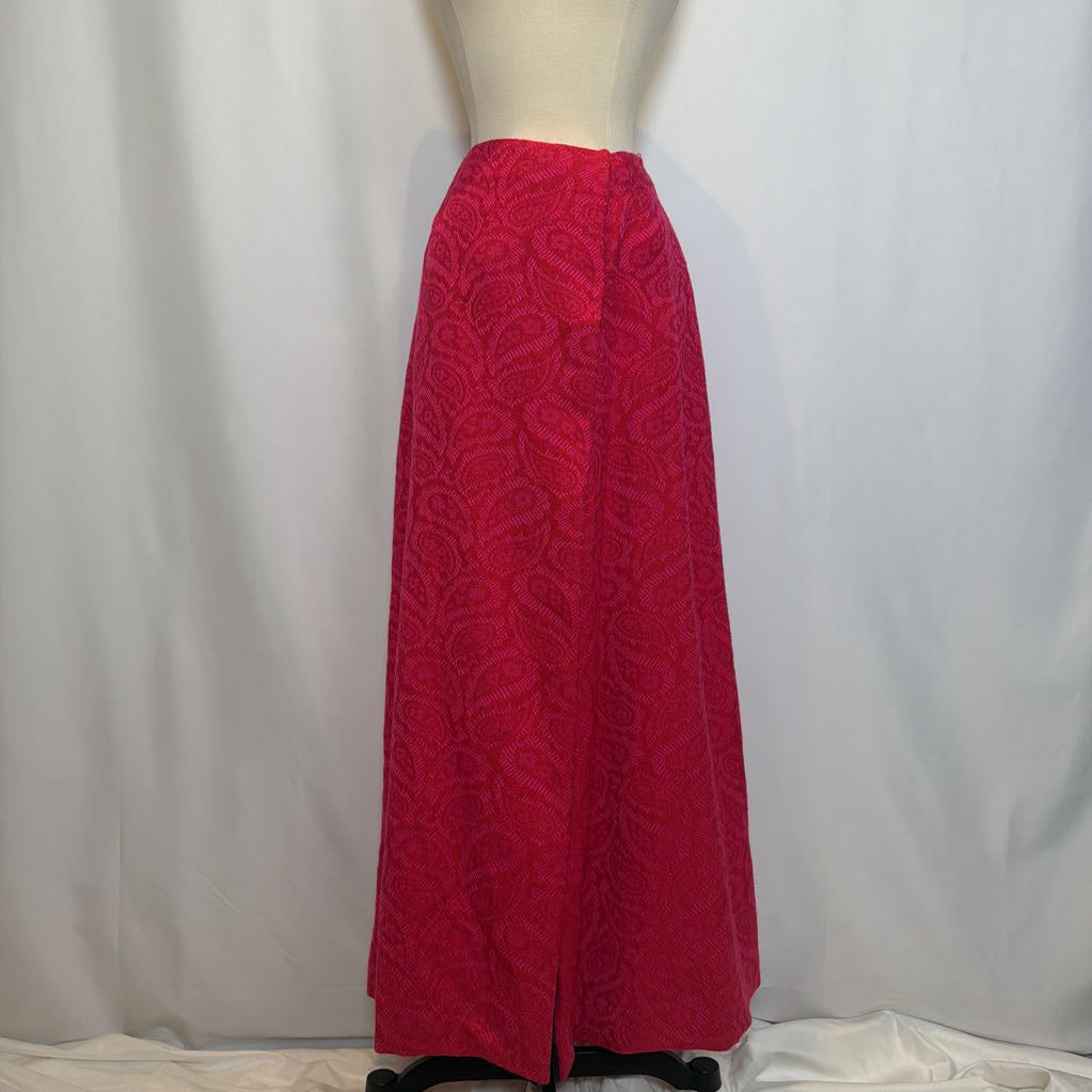 Red patterned skirt on a mannequin against a plain background
