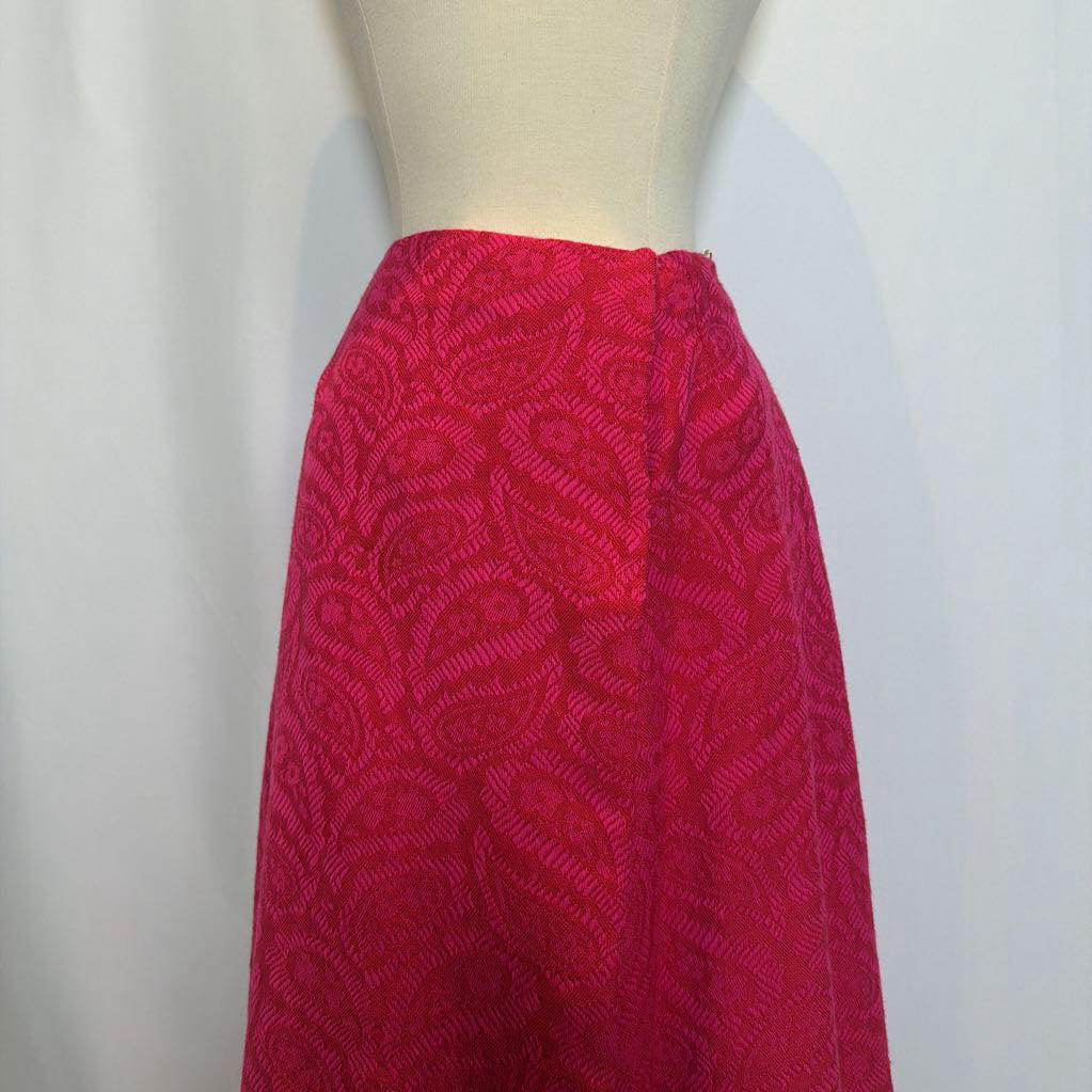 Red patterned skirt on a mannequin against a white background