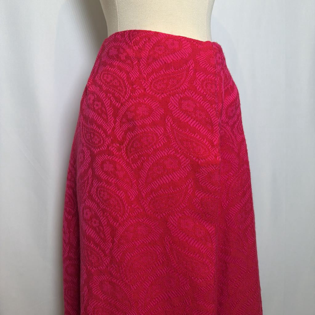 Red patterned skirt on a mannequin against a white background