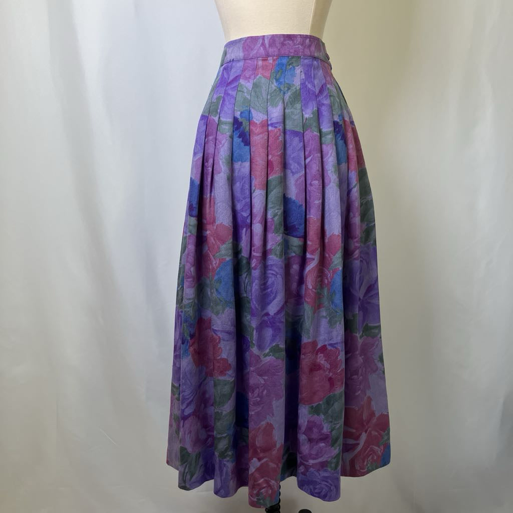 Colorful floral skirt on a mannequin against a white background