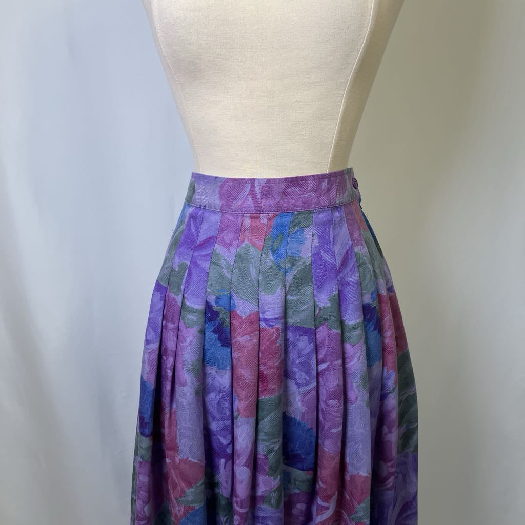 Colorful floral skirt on a mannequin against a plain background