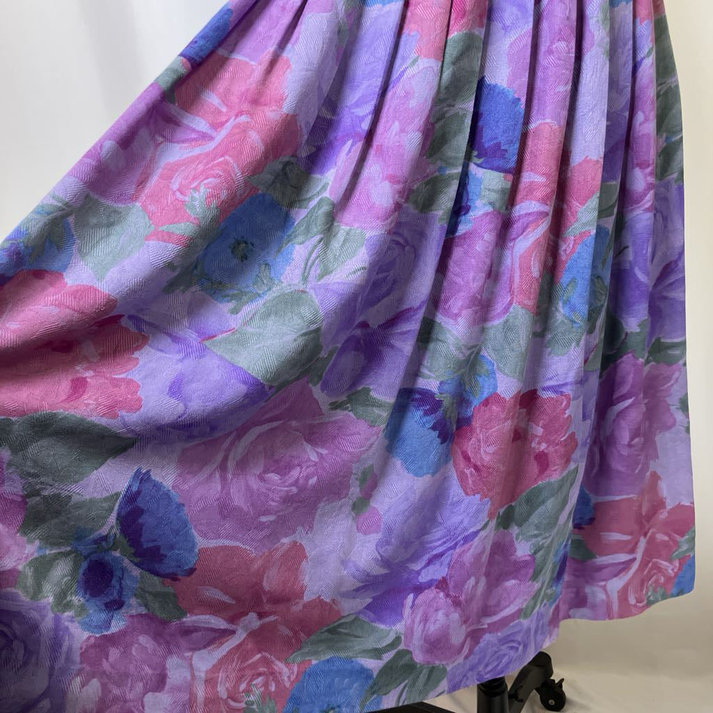 Floral patterned fabric with pink, purple, and blue colors on a white background