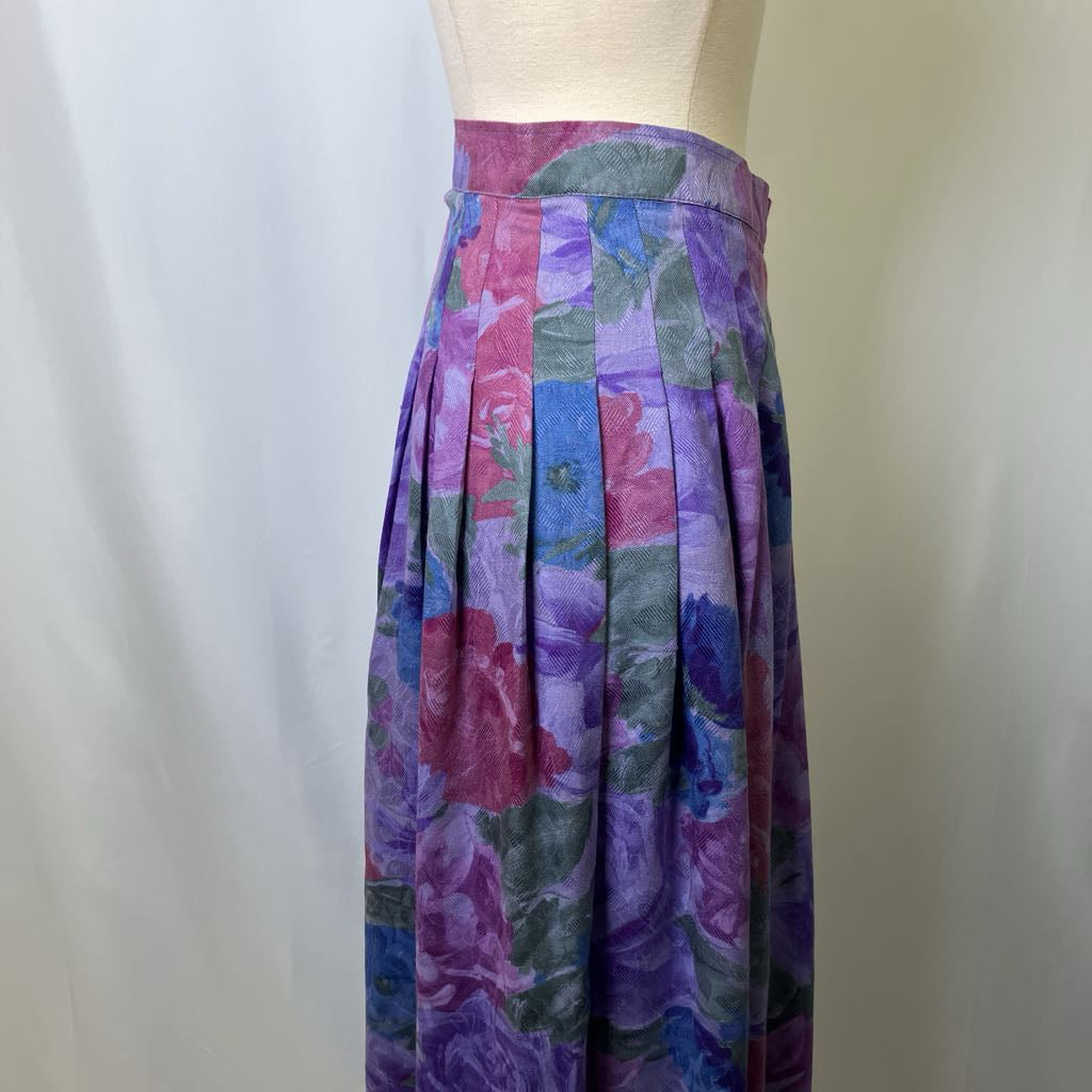 Colorful floral skirt on a mannequin against a plain background