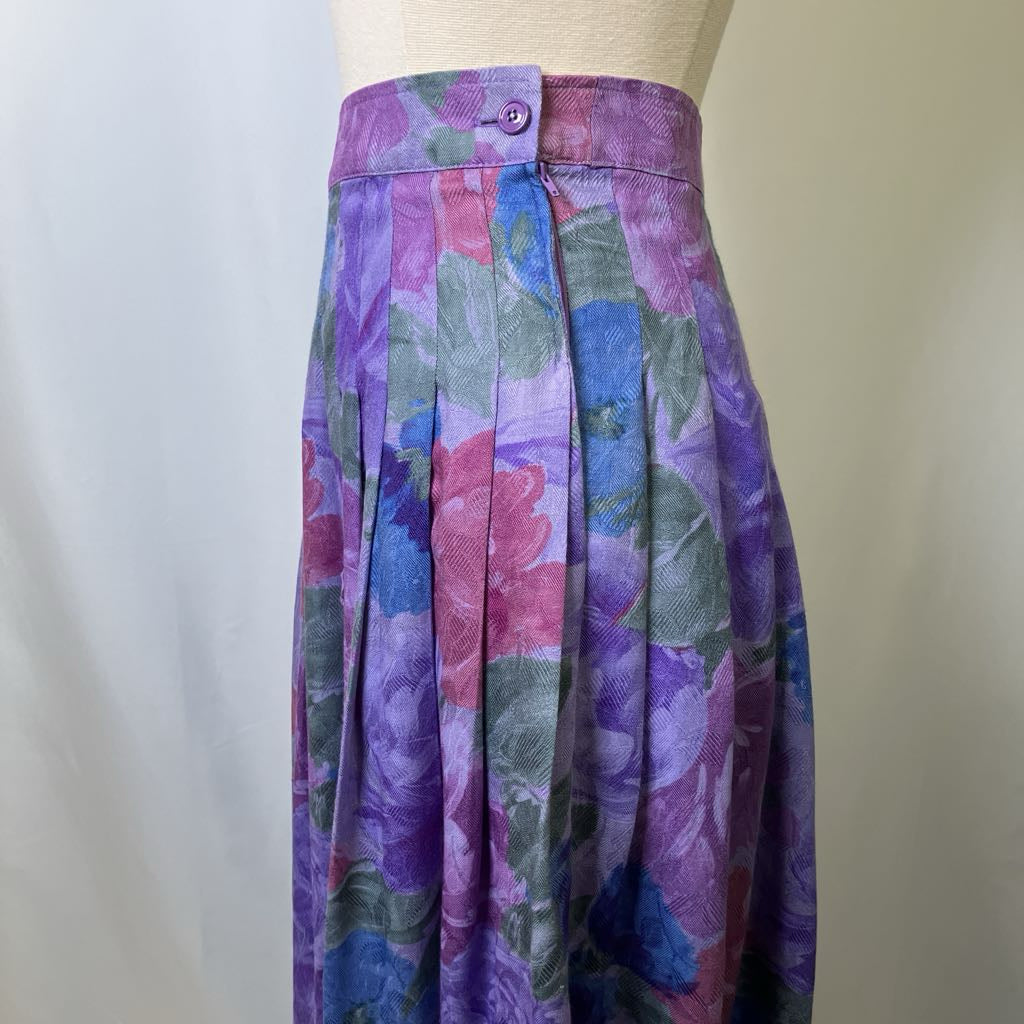 Multicolored floral skirt on a mannequin against a plain background