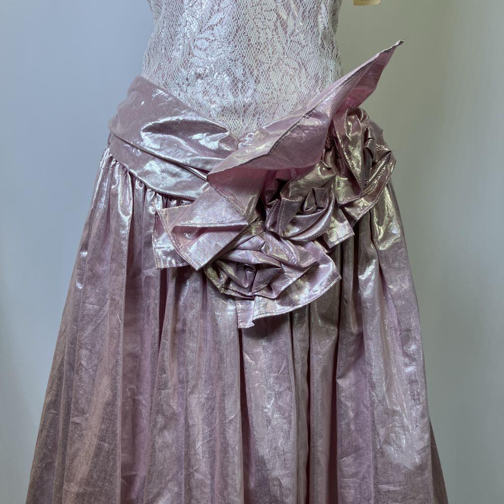 Vintage dress with a large floral bow on a plain background