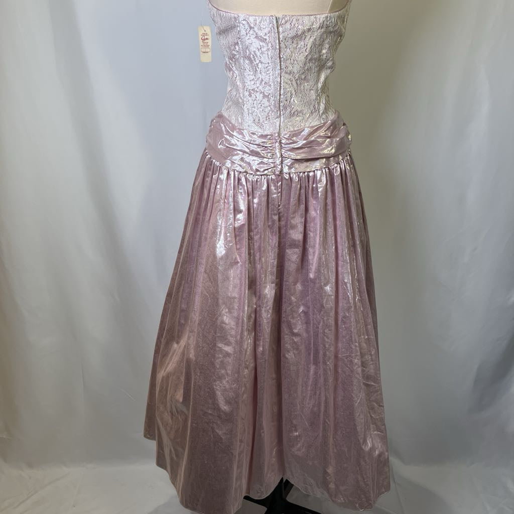 Mannequin wearing a pink metallic dress against a plain background