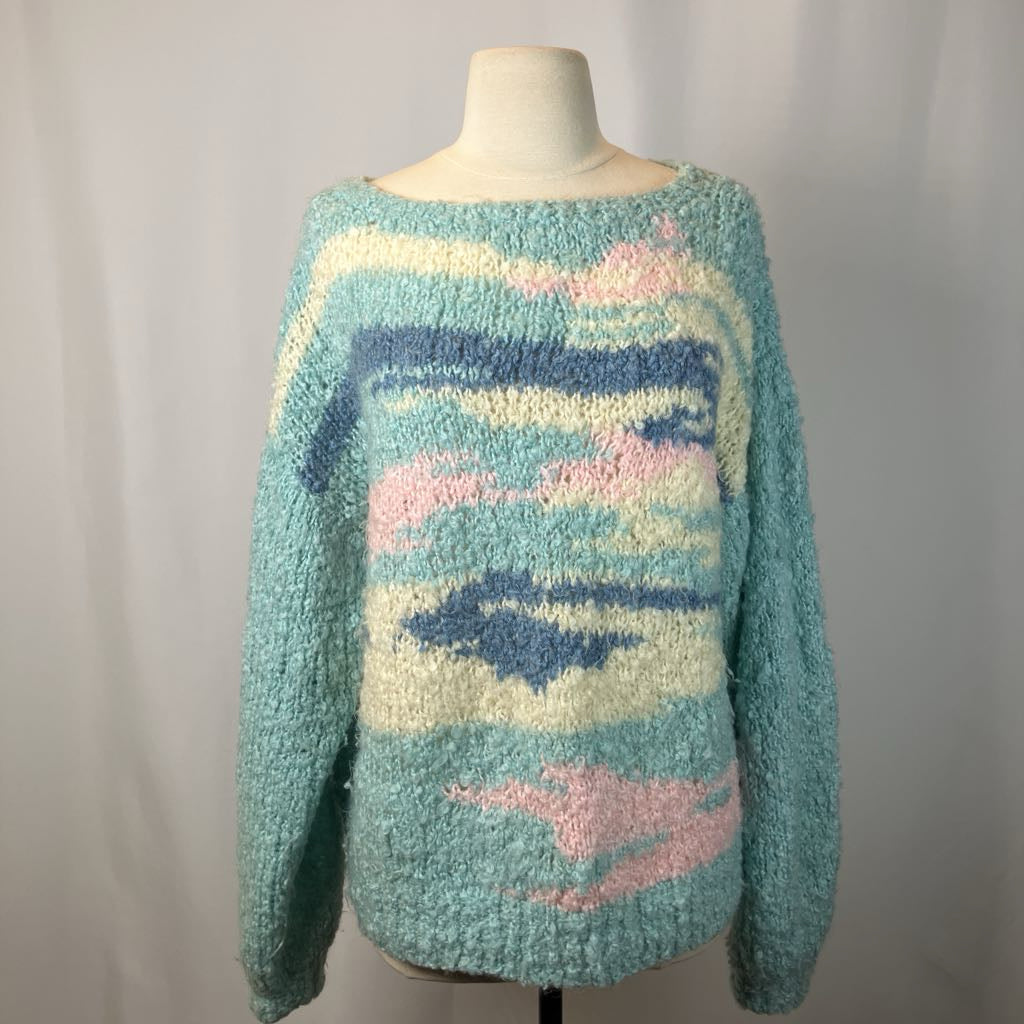 Pastel patterned sweater on a mannequin against a plain background