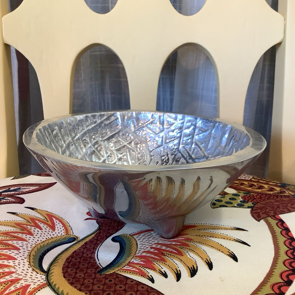 Pewter bowl with texture with patterned background