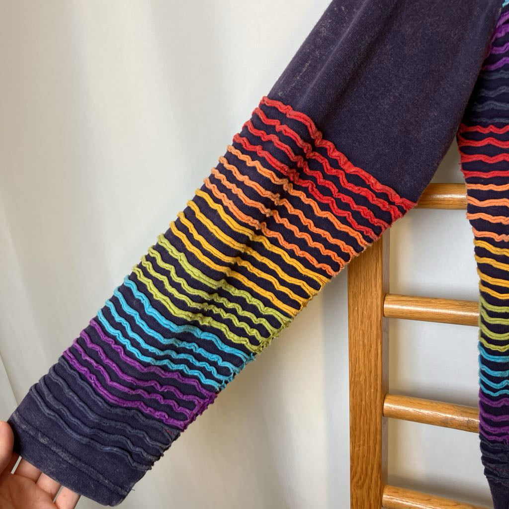 Colorful striped sleeves on a person's arm with a white background