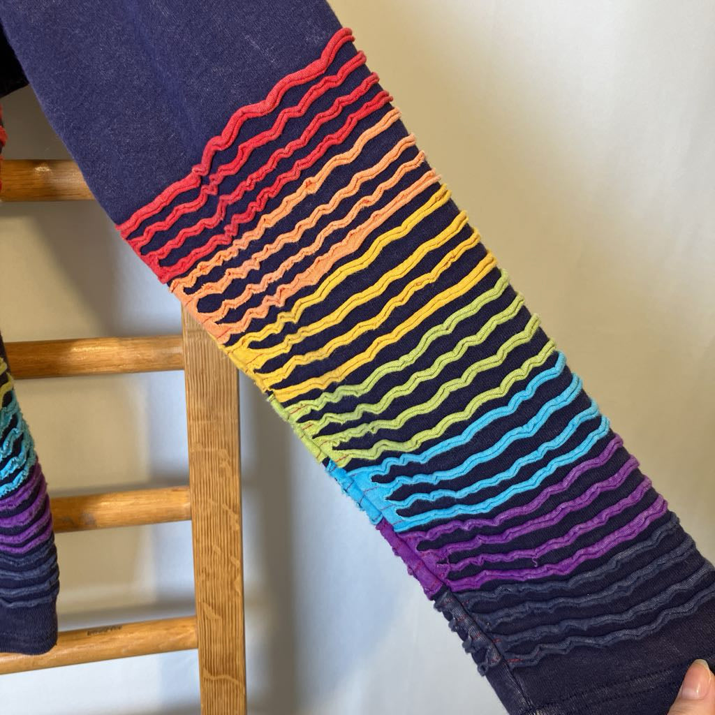 Colorful striped sleeve on a wooden chair with a plain background