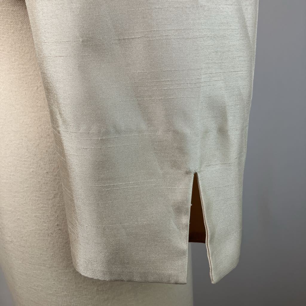 Close-up of beige pants with a cut-out design on a gray background