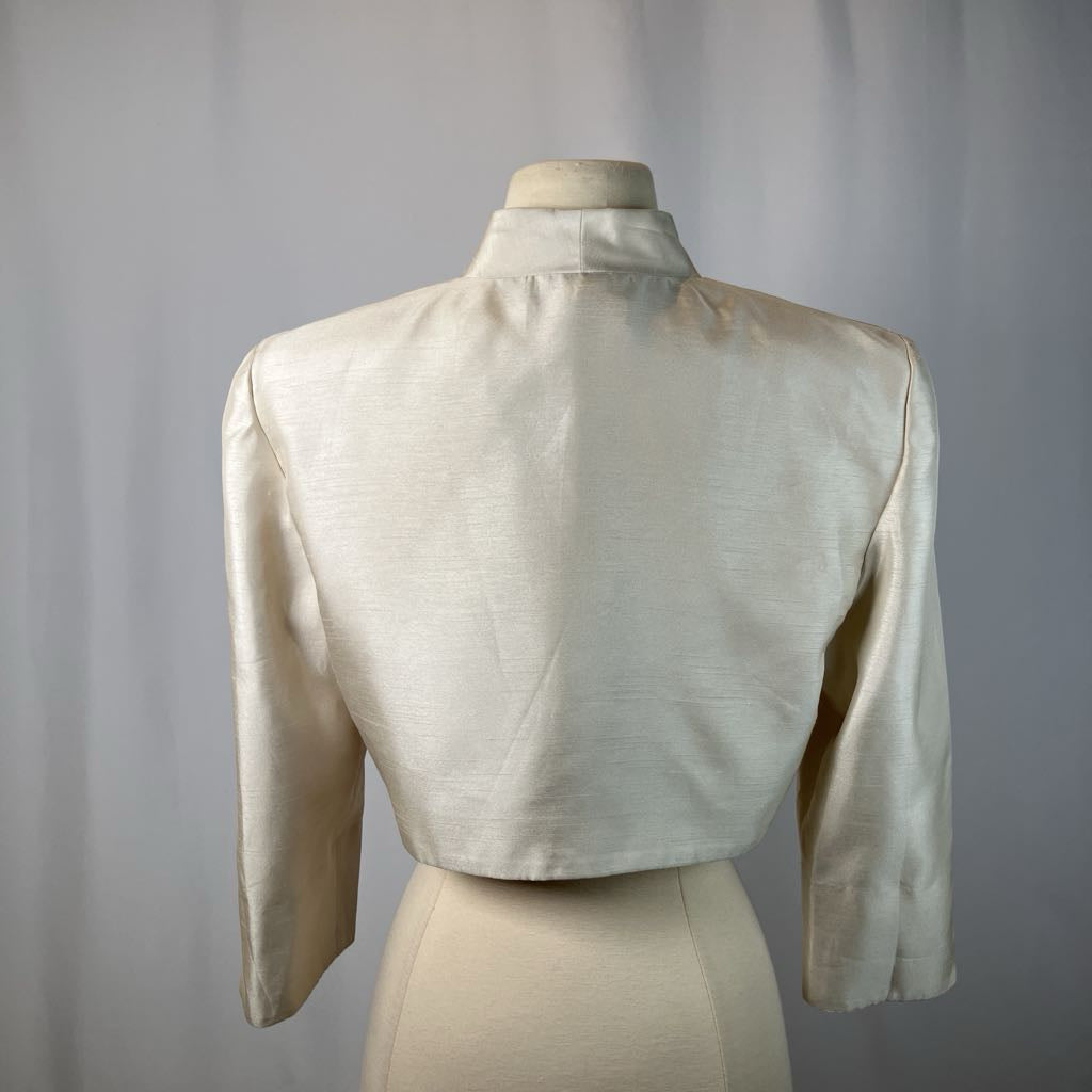 Beige blazer on a mannequin against a gray background