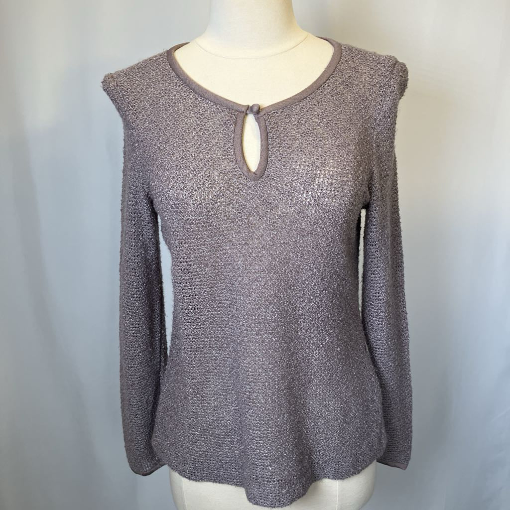 Gray knit sweater on a mannequin against a white background