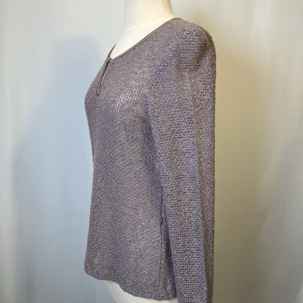 Mannequin wearing a textured gray sweater against a plain background