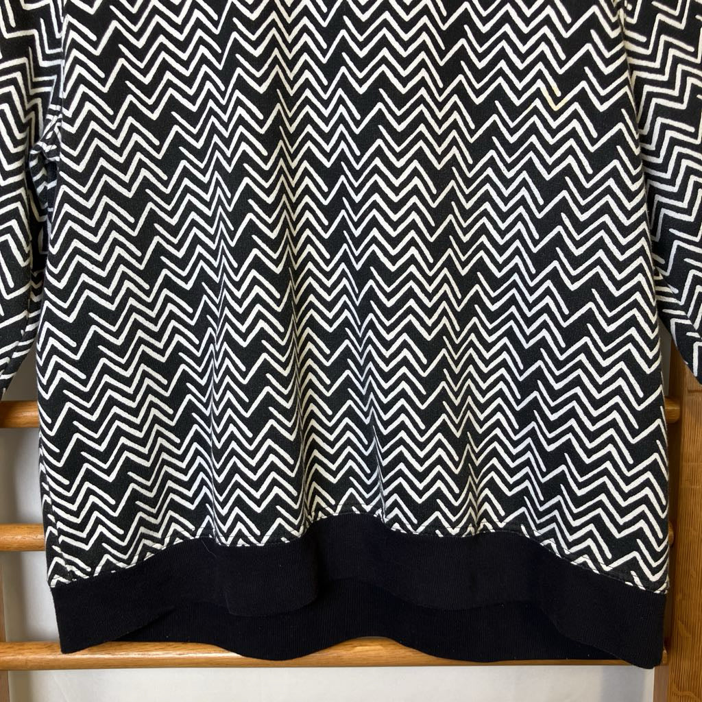 Black and white zigzag patterned shirt on a wooden hanger