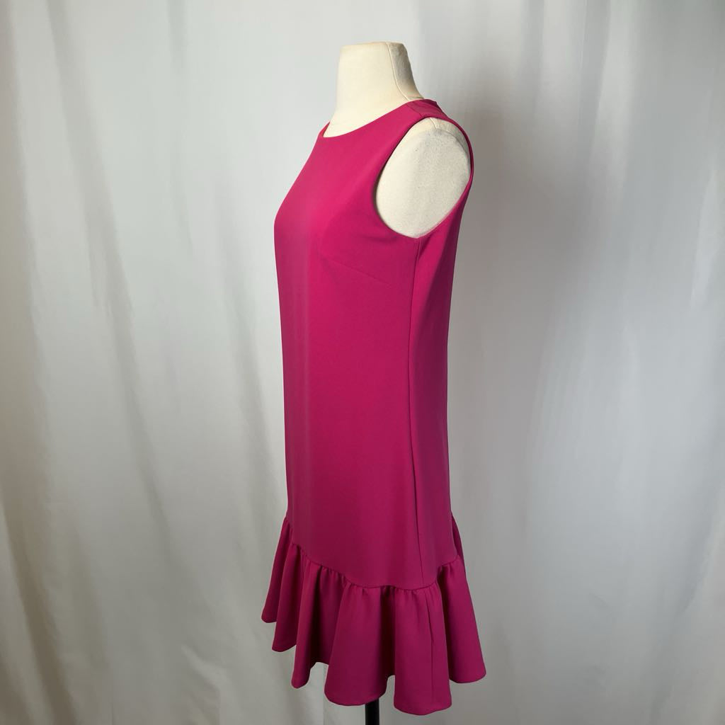 Pink dress on a mannequin against a white background