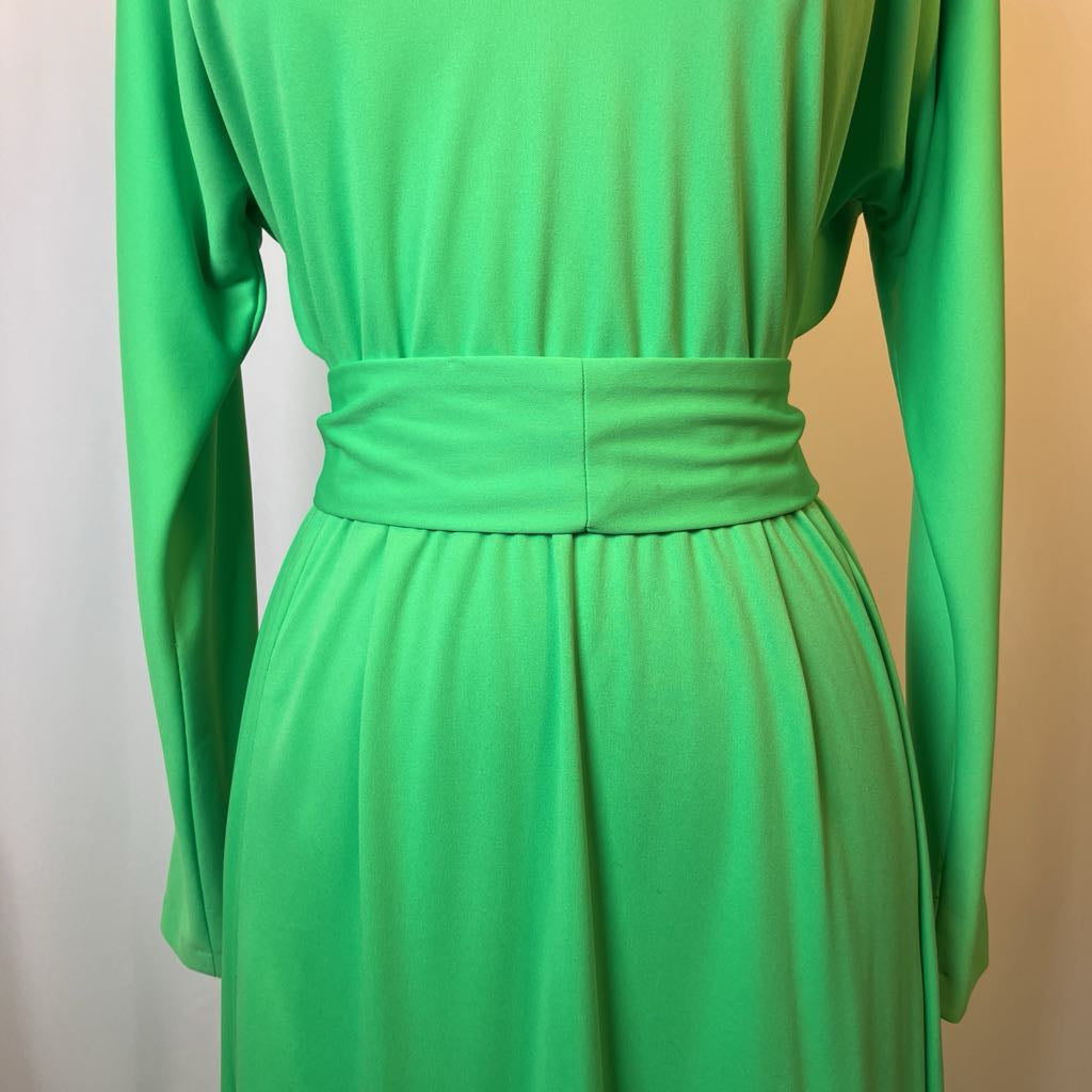 Green dress with long sleeves on a plain background