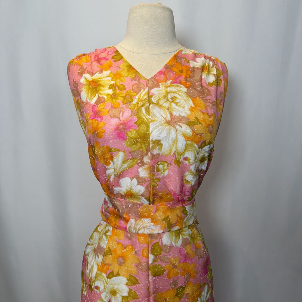 Floral dress on a mannequin against a plain background