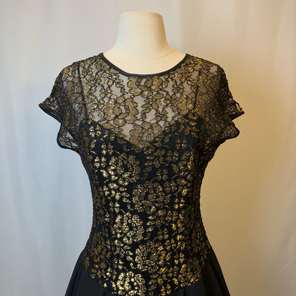 Black lace dress on a mannequin against a neutral background