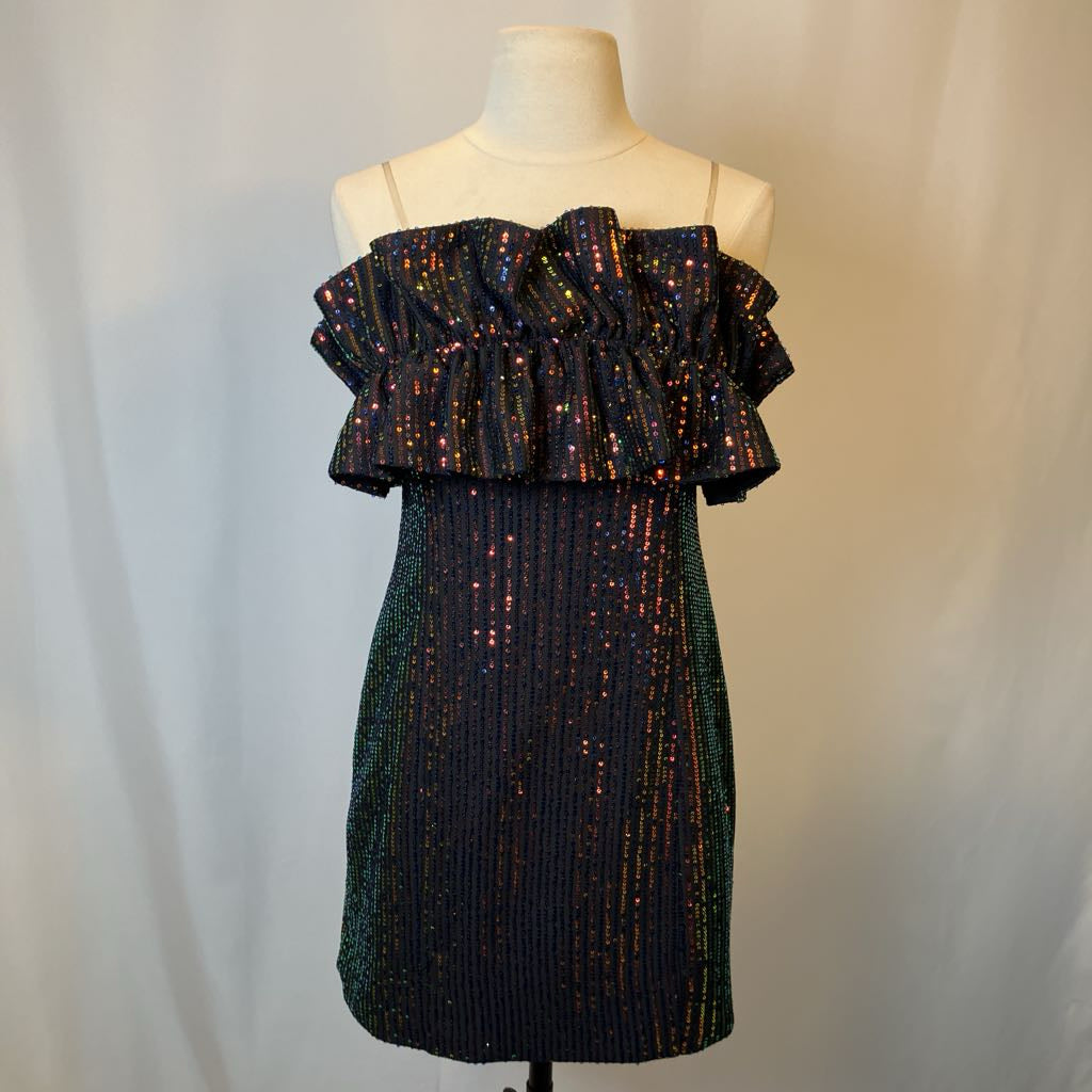 Black sequin dress on a mannequin against a plain background