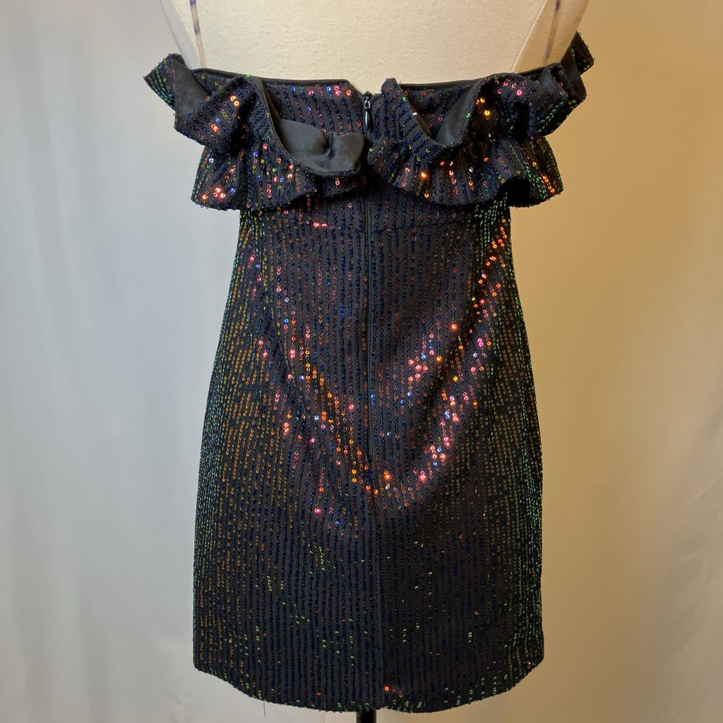 Black sequin dress on a mannequin against a neutral background