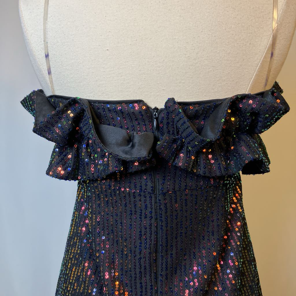 Black sequined dress on a mannequin with a blurred background
