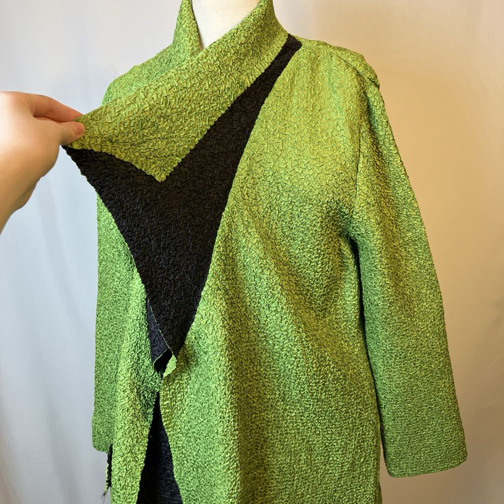 Green textured jacket collar draped over a mannequin with a neutral background