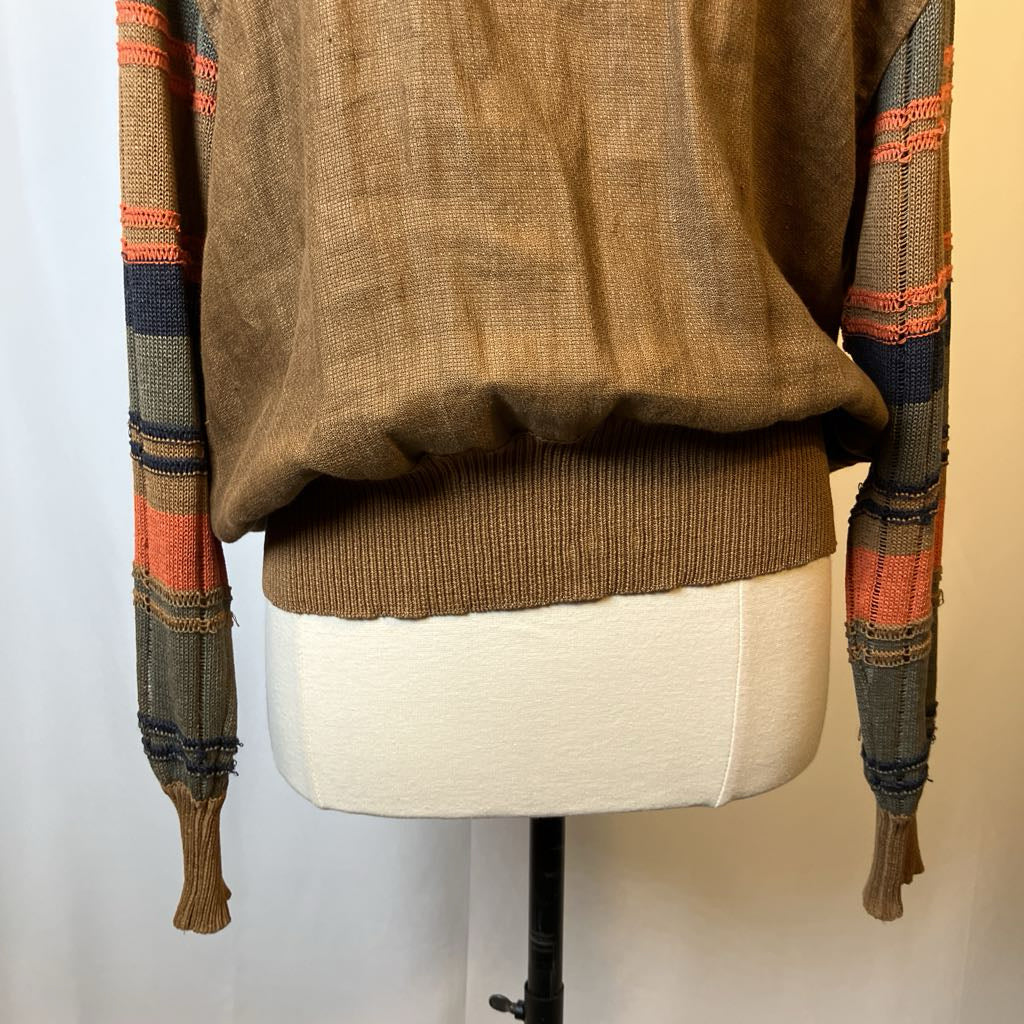 Brown sweater with plaid sleeves on a mannequin against a plain background