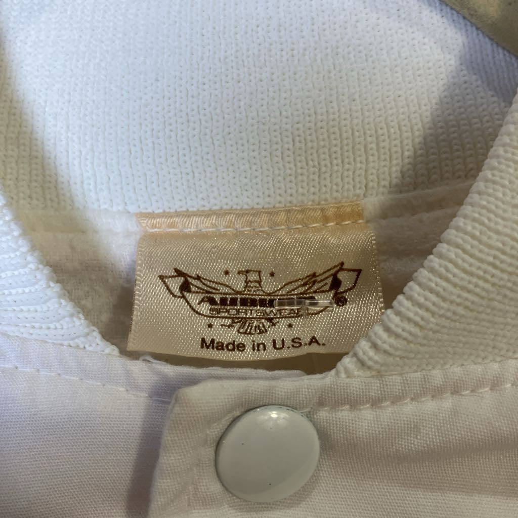 Close-up of a label on a white shirt with 'Aurora Sportswear' branding and 'Made in U.S.A.' text.