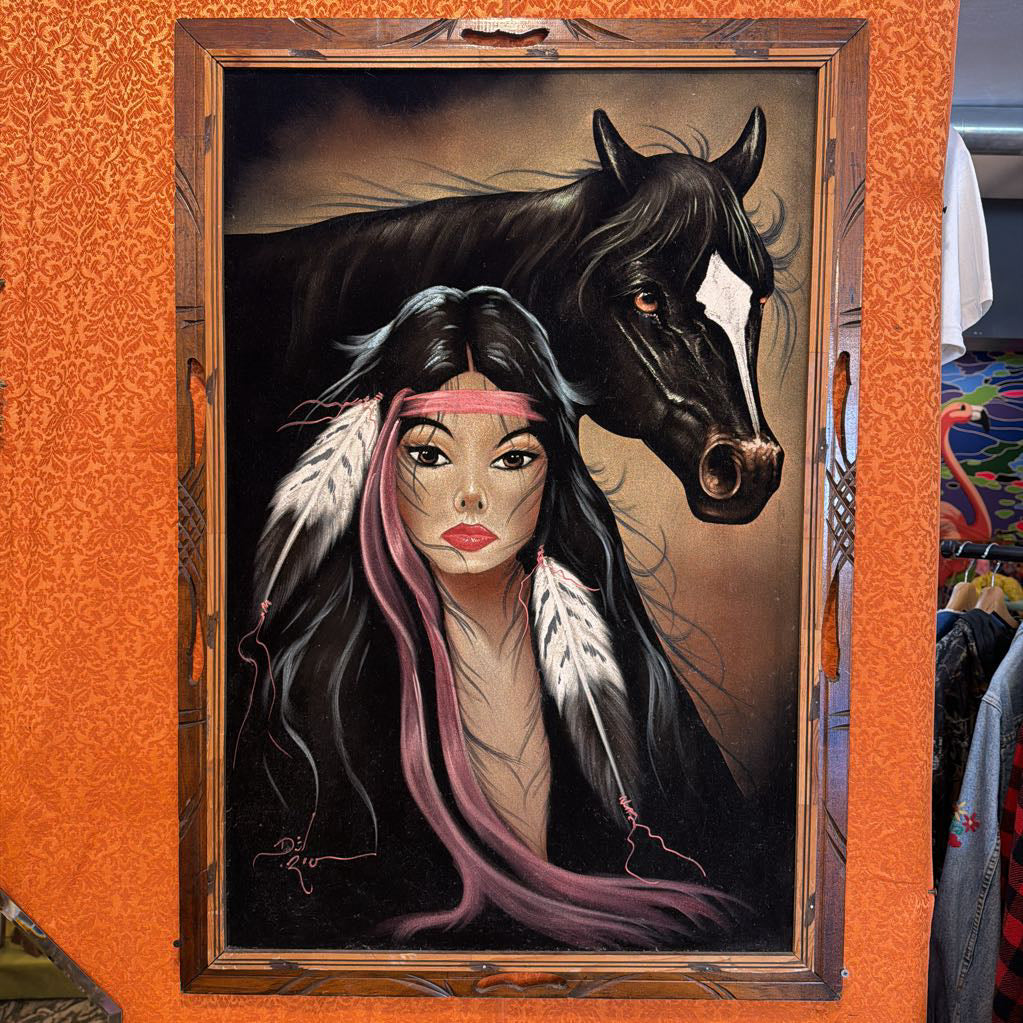 Artistic depiction of a woman with a horse in a wooden frame.