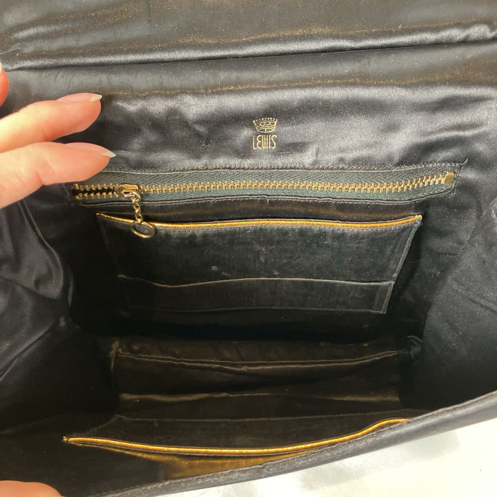 Black leather handbag with gold zipper and visible Lewis logo.