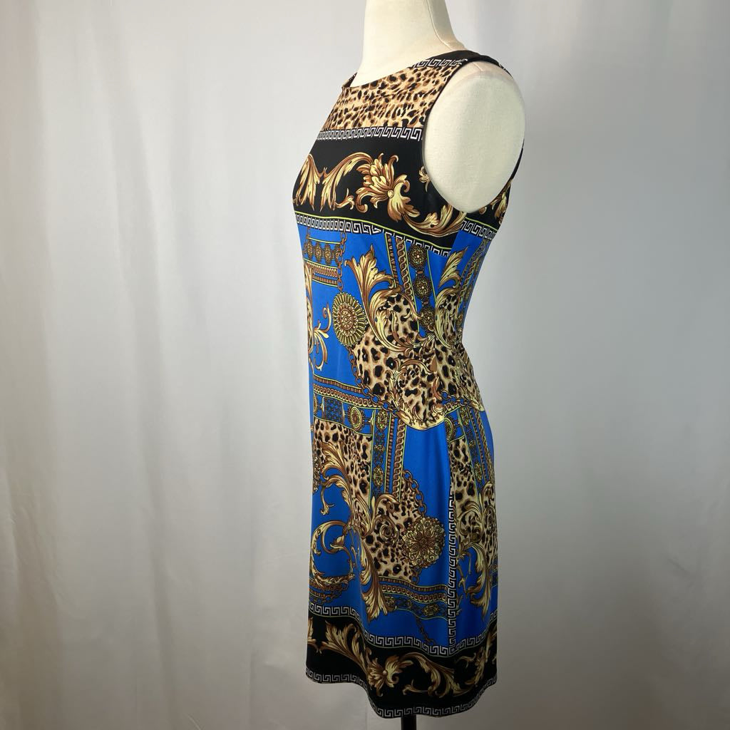 Dress with leopard print and baroque patterns on a mannequin against a plain background