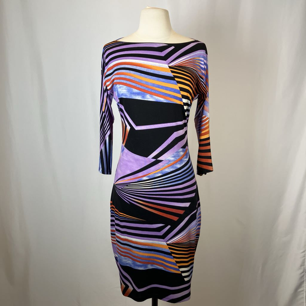 Colorful striped dress on a mannequin against a plain background