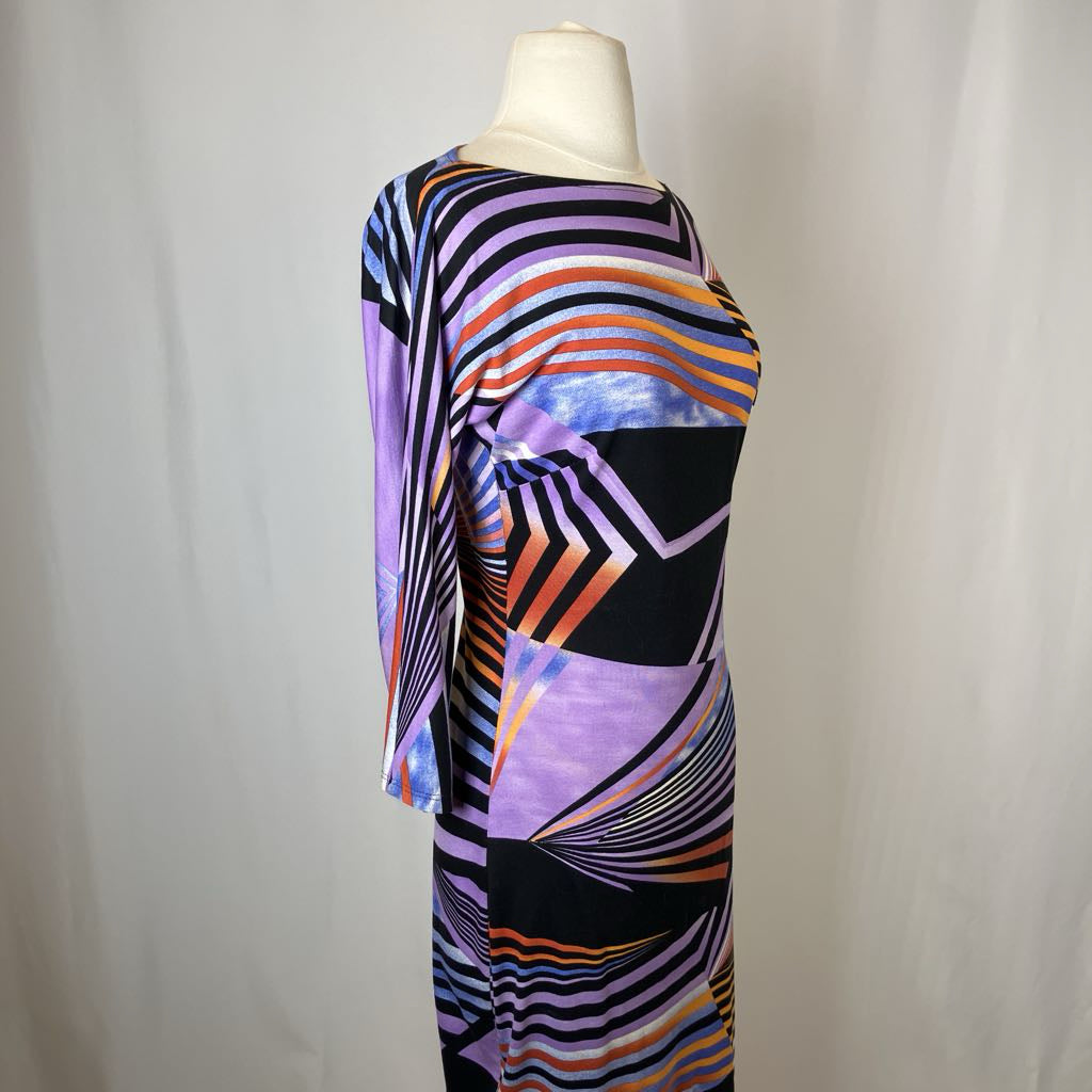 Colorful abstract patterned dress on a mannequin against a plain background