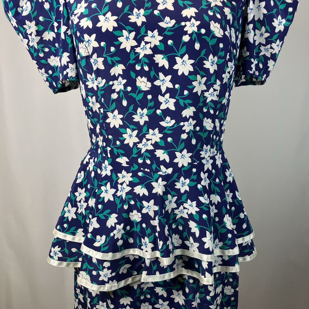 Navy blue dress with white floral pattern on a mannequin against a plain background
