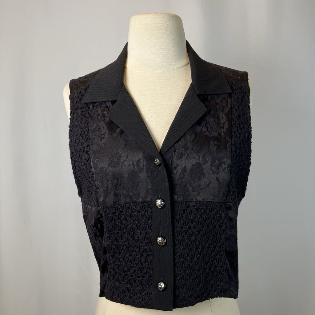 Black vest on a mannequin against a gray background