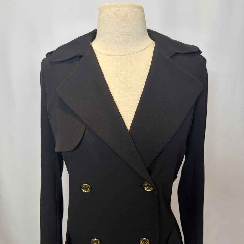 Black coat dress with gold buttons on a mannequin against a white background