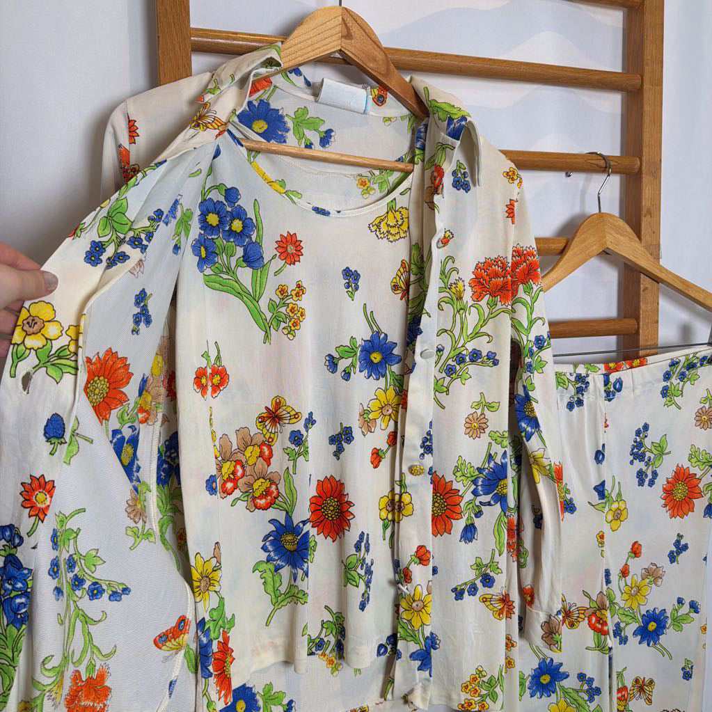 Floral-patterned shirt on a hanger with a wooden rack in the background