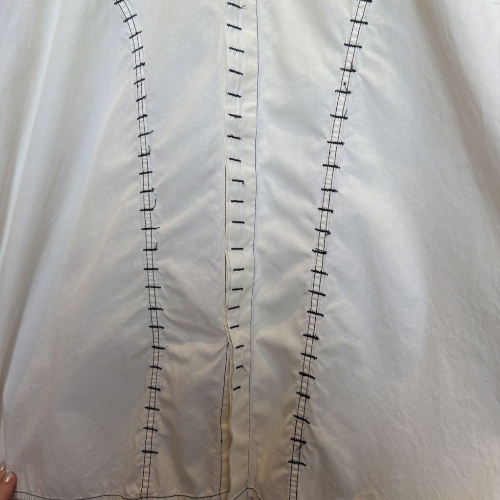 Close-up of a white fabric with black stitching details