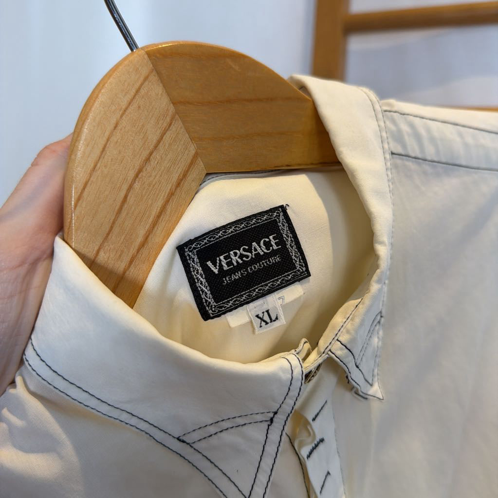 White shirt with Versace label on a wooden hanger